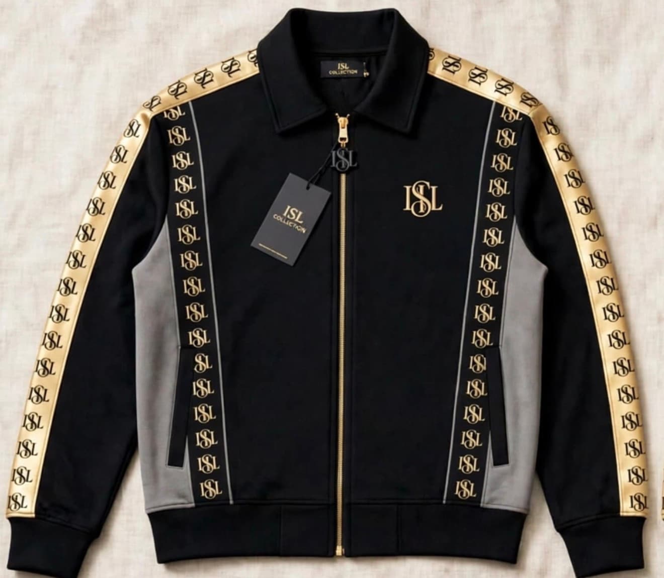 The ISL tracksuit in black with gold taping, front view, zipped